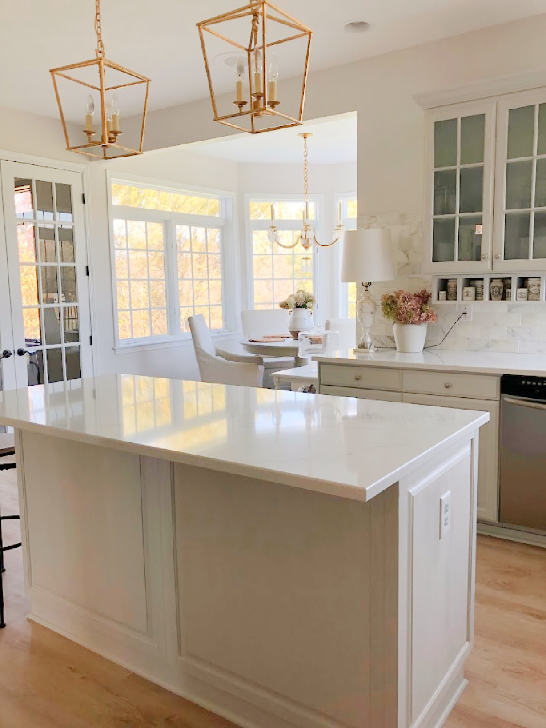 Renovated kitchen with Viatera Muse countertops and Sherwin Williams Eider White paint color. Cabinets are 50% Farrow & Ball Pavilion Gray - Hello Lovely Studio.