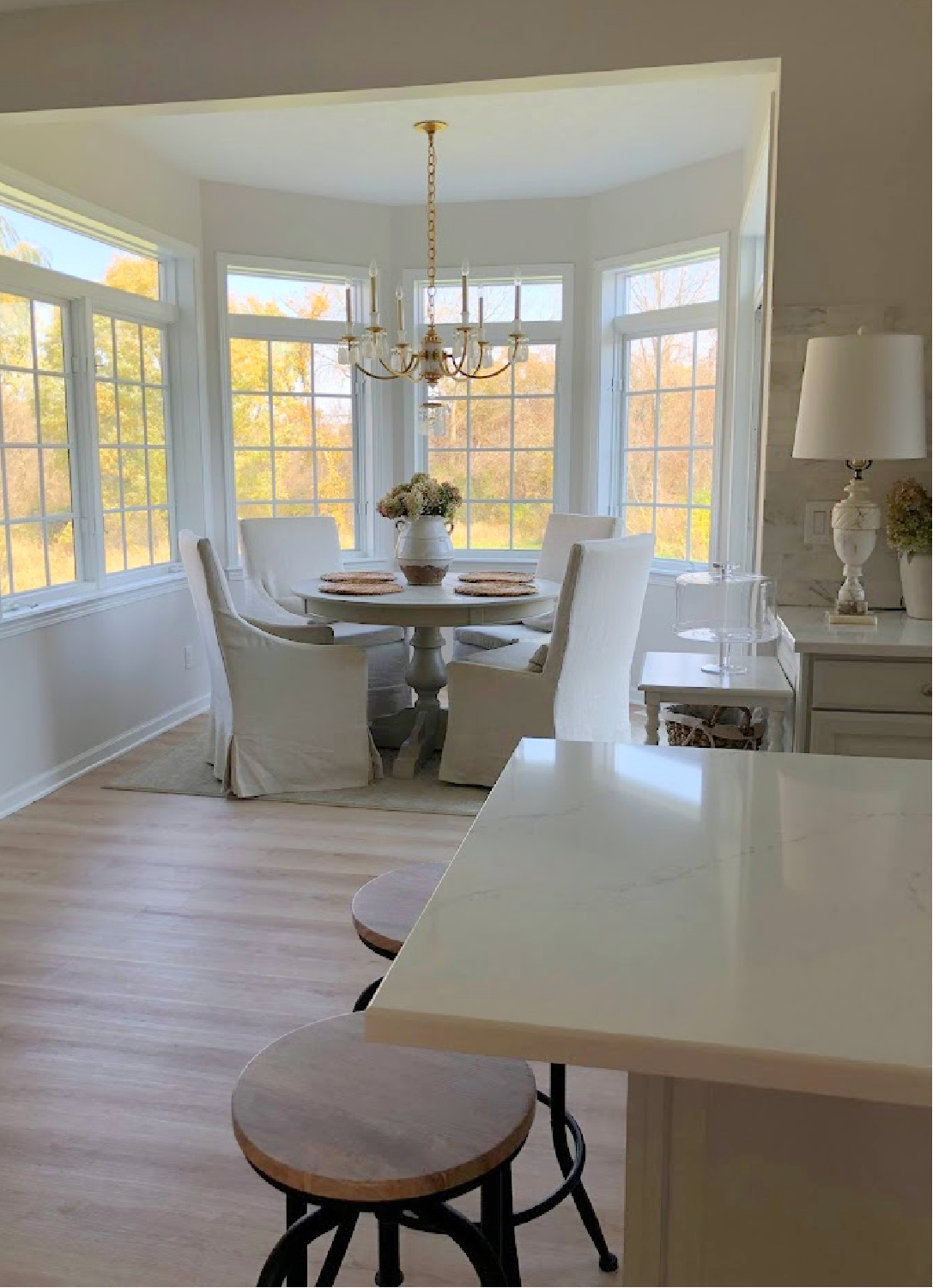 Renovated kitchen with Viatera Muse countertops and Sherwin Williams Eider White paint color. Cabinets are 50% Farrow & Ball Pavilion Gray - Hello Lovely Studio.