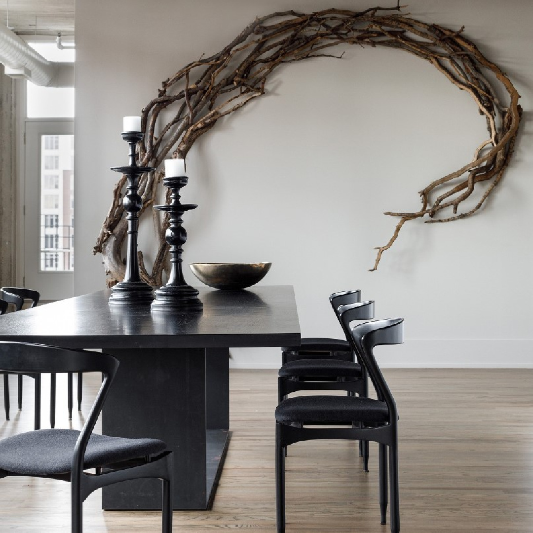 Michael Del Piero designed modern organic luxe dining room with rustic root as sculpture on wall.