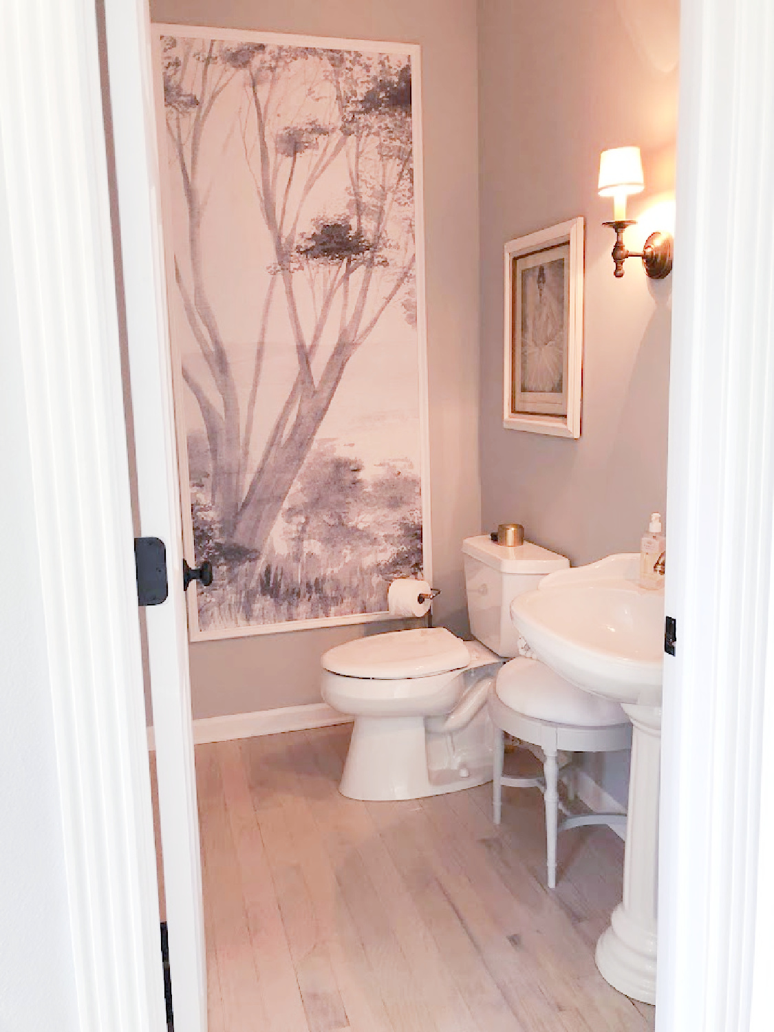 Powder bath in Georgian renovation with framed grisaille tree mural - Hello Lovely Studio.