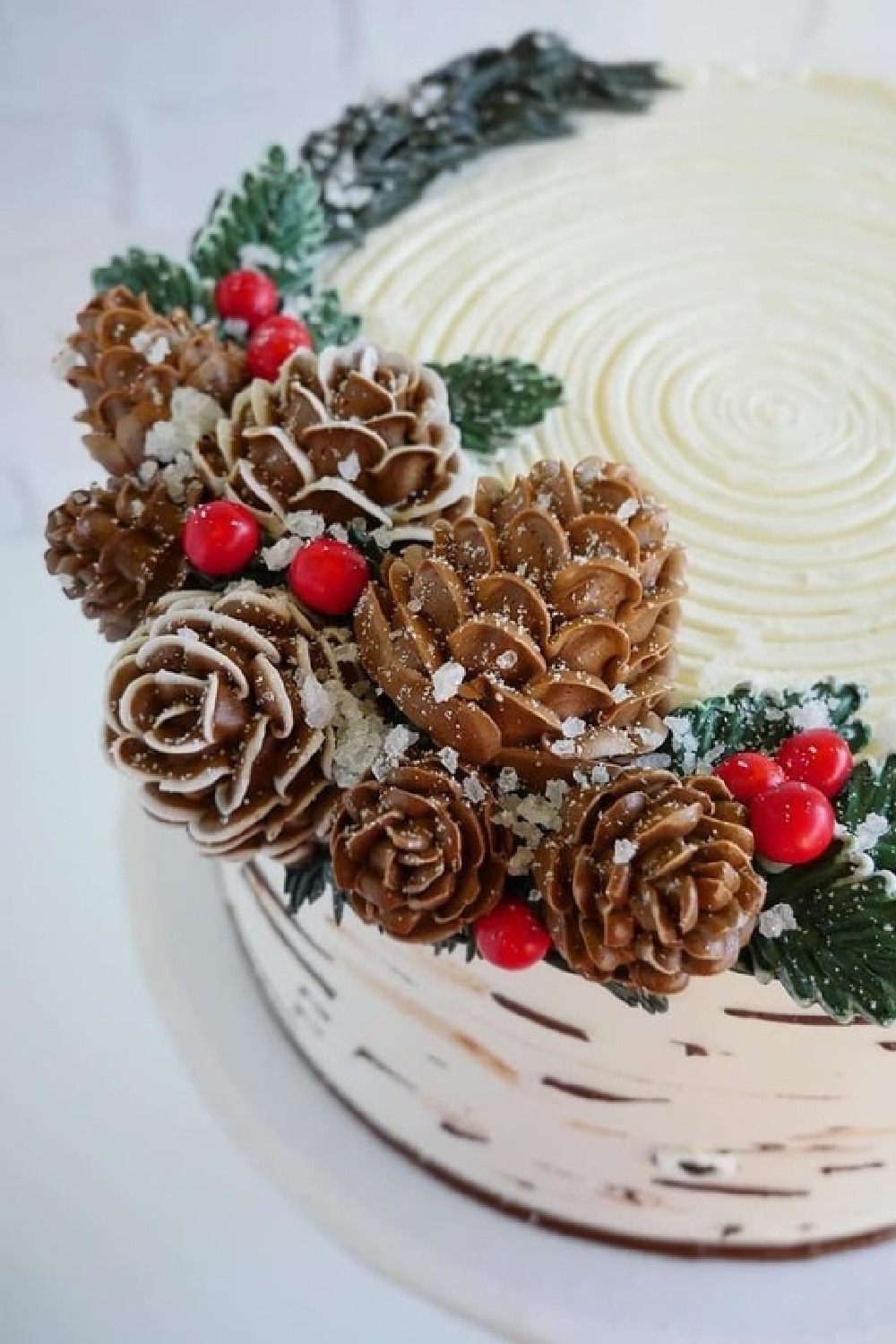 Fanciful Christmas cake decorated with edible pinecones, holly, and boughs - AVeryMerryChristmasWorld on Tumblr. #christmasbaking #christmascake