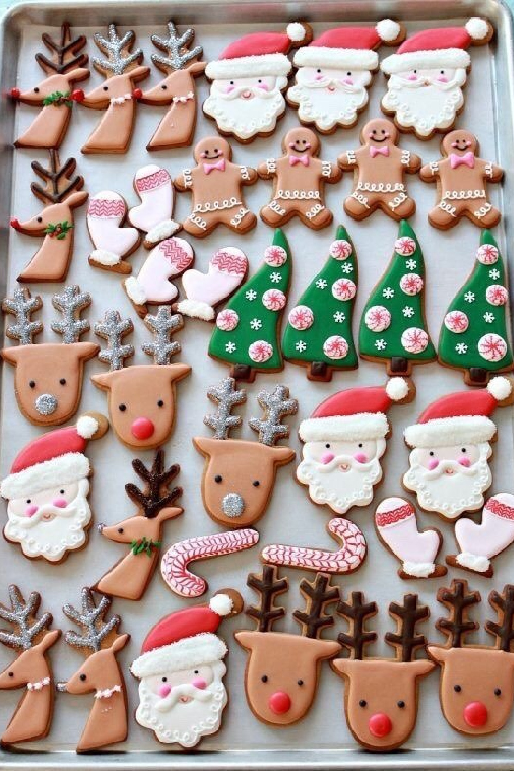 Decorated Santa, tree, reindeer, and candycane cookies on cookie sheet - @allthingsshabbyandbeautiful-dea. #christmascookies