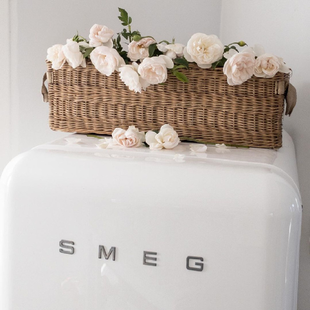 Vintage Smeg refrigerator with antique French basket on top filled with blush pink Francis Meilland roses - My Petite Maison.
