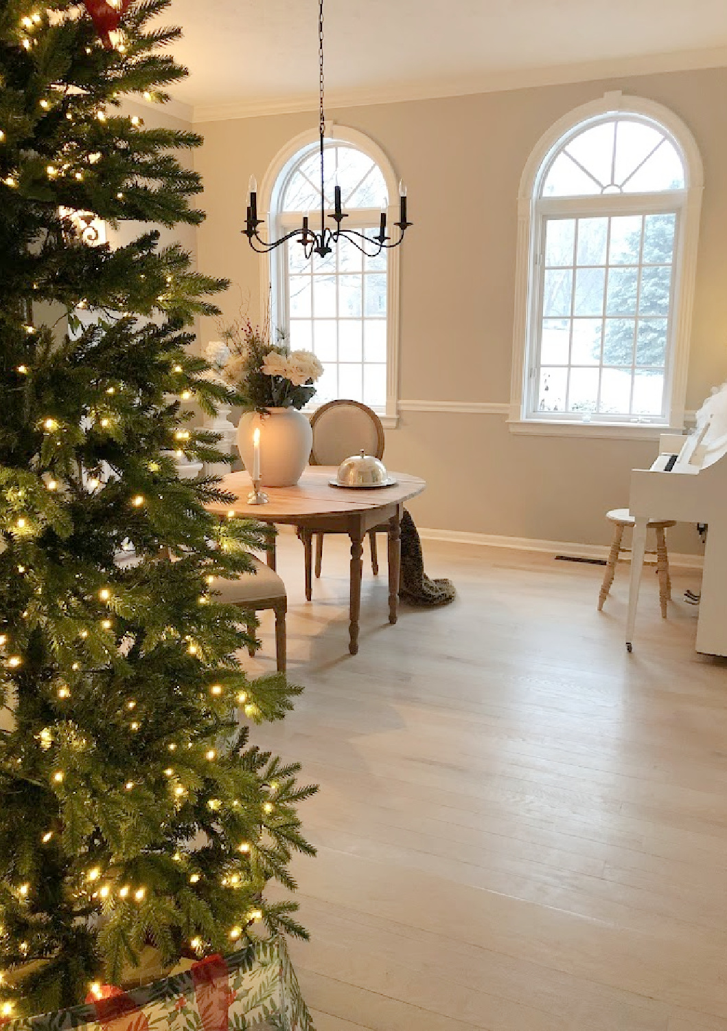 Our renovated dining room turned music room at the Georgian has arched windows, light greyed oak floors, and European country style - Hello Lovely Studio.