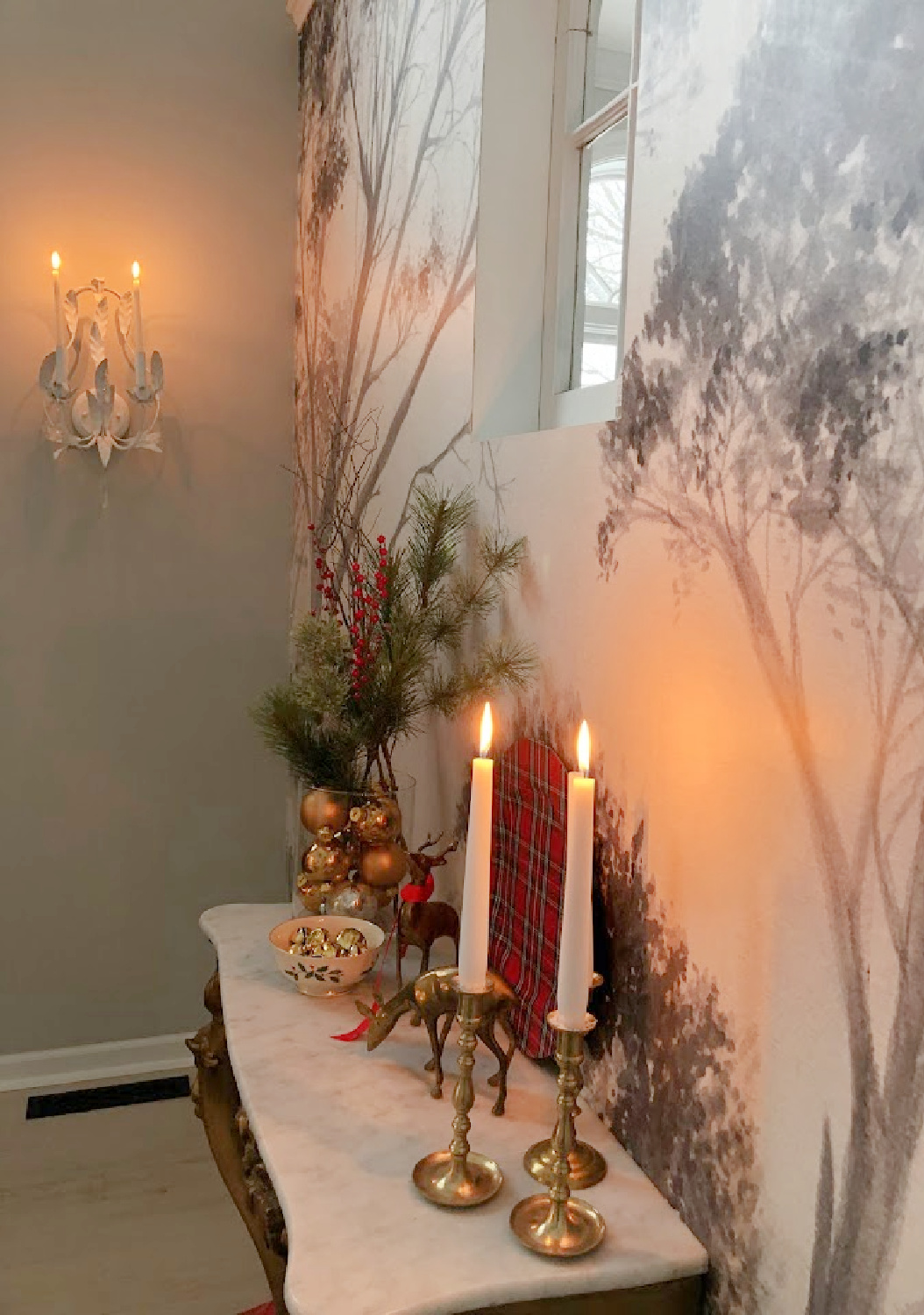 Scenic tree wallpaper mural and French console decorated for Christmas in our Georgian entry - Hello Lovely Studio.