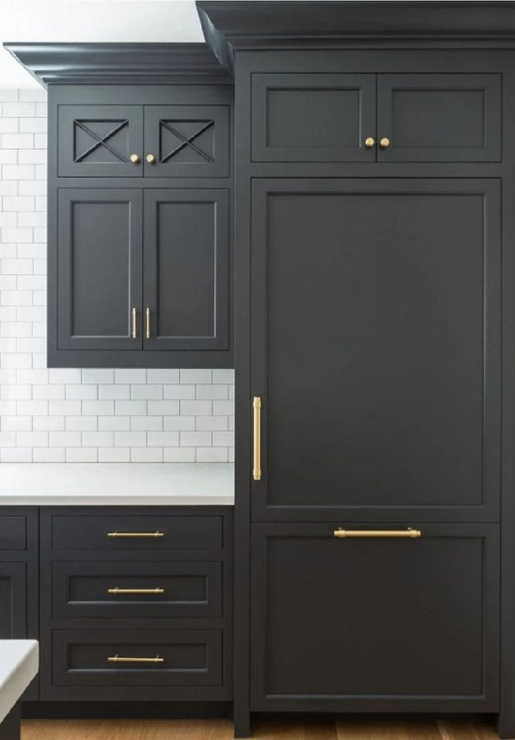 Benjamin Moore Cheating Heart - a black paint color on these kitchen cabinets in a design by The Fox Group. #cheatingheart #blackcabinets
