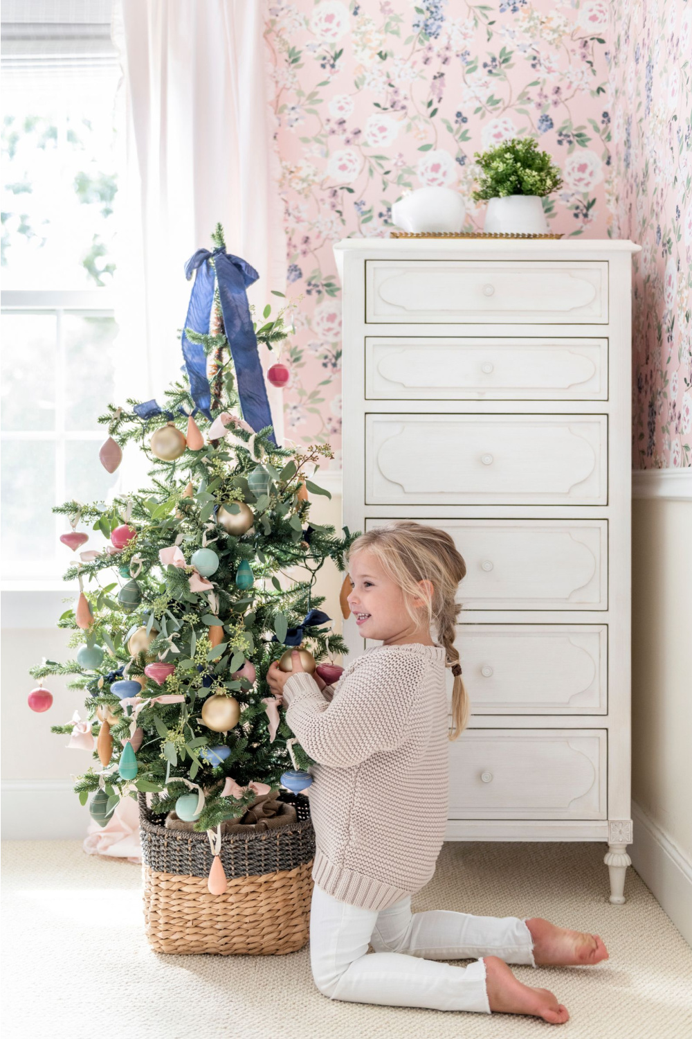 Brooke and Lou's holiday collection 2019 - a lovely little Christmas tree in a girl's room with pink floral wallpaper...charming! #brookeandlou #pinkchristmas #kidsrooms