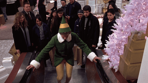gif result for funny Elf escalator scene Will Ferrell Christmas movie
