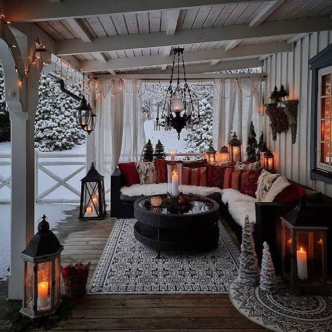 Cozy country cabin patio with lanterns, candlelight, sectional, and rustic winter vibes - CountryGirlatHeart. #cozywinter #cozychristmas