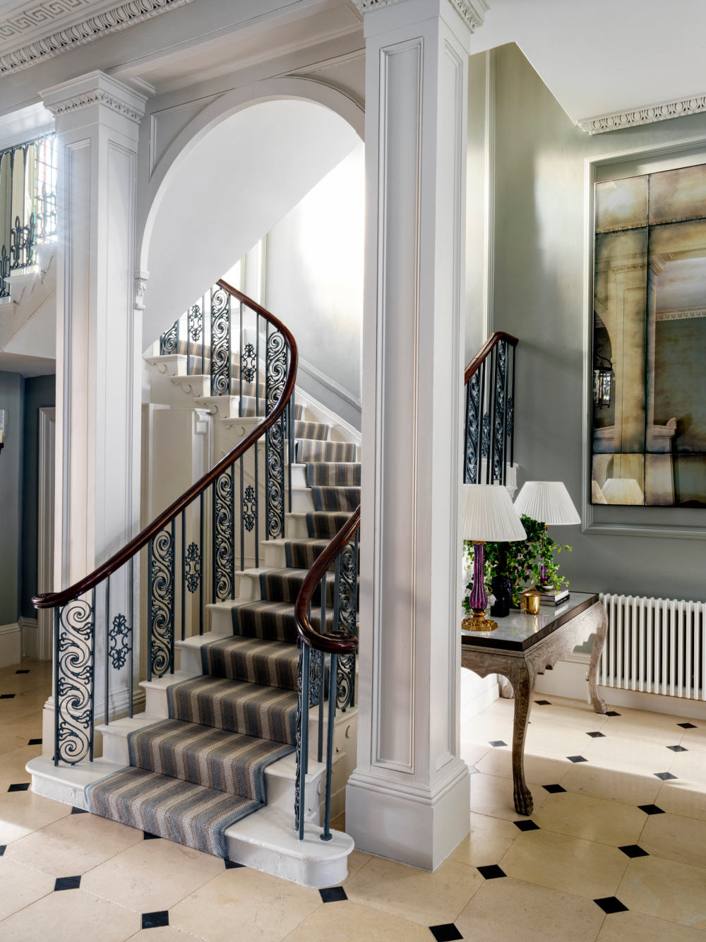 Luxurious winding staircase in an English Country townhouse with design by Sims Hilditch in THE EVOLUTION OF HOME (Rizzoli, 2022).