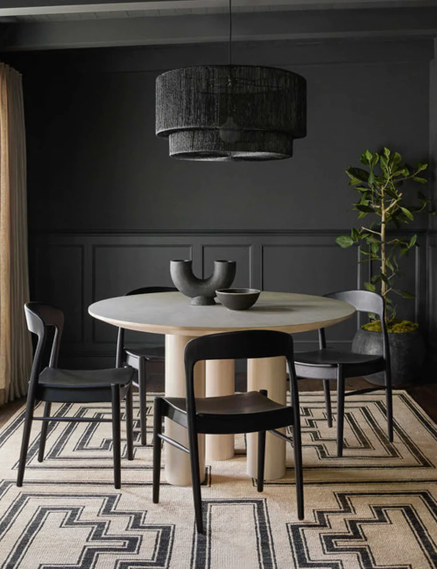 Black walls in dining room with Sayan pendant light, Lulu & Georgia.