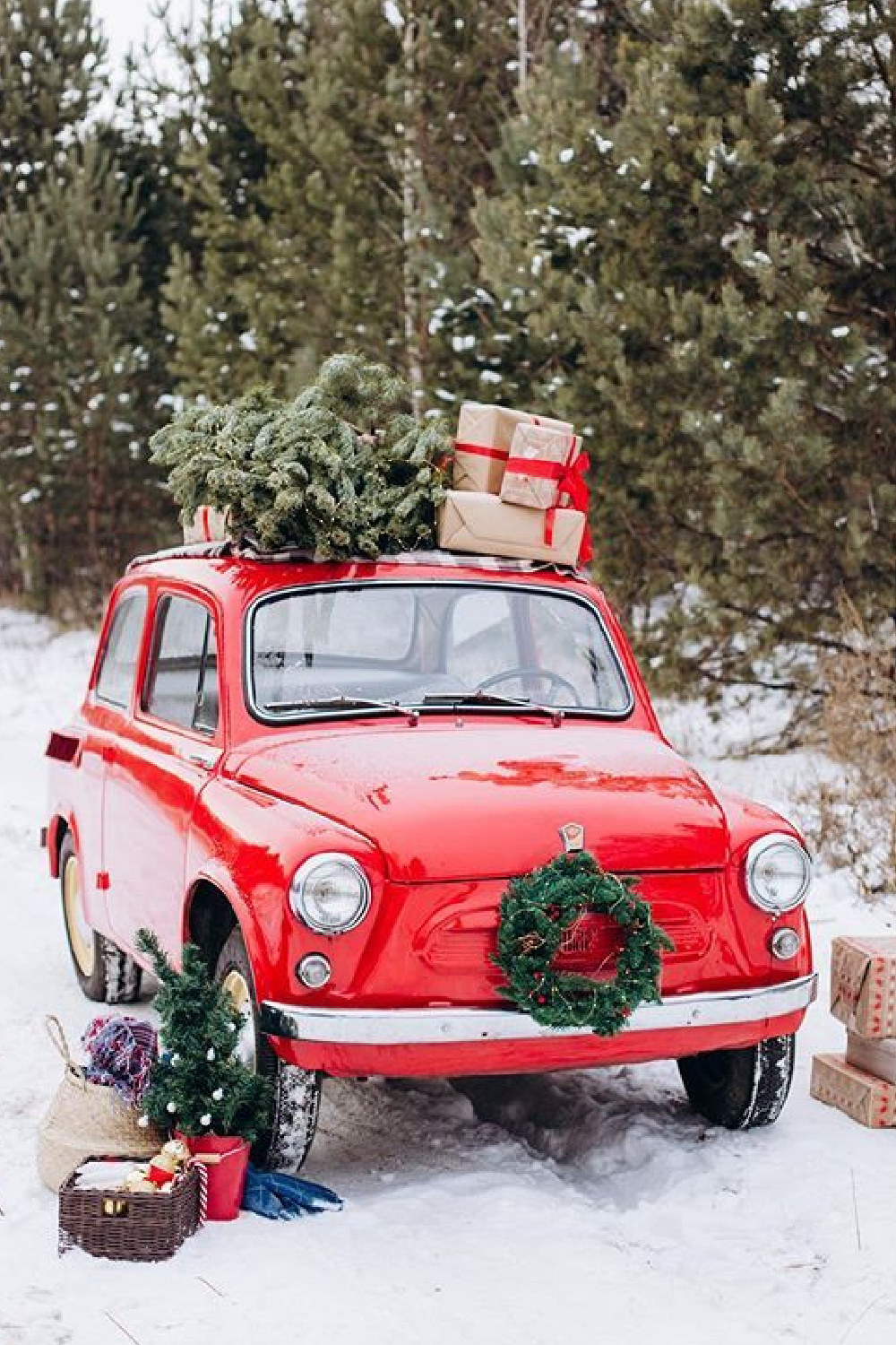 Red Christmas car loaded with tree, wreath, and holiday cheer - #katrindiitrih. #christmascozy #christmasroadtrip