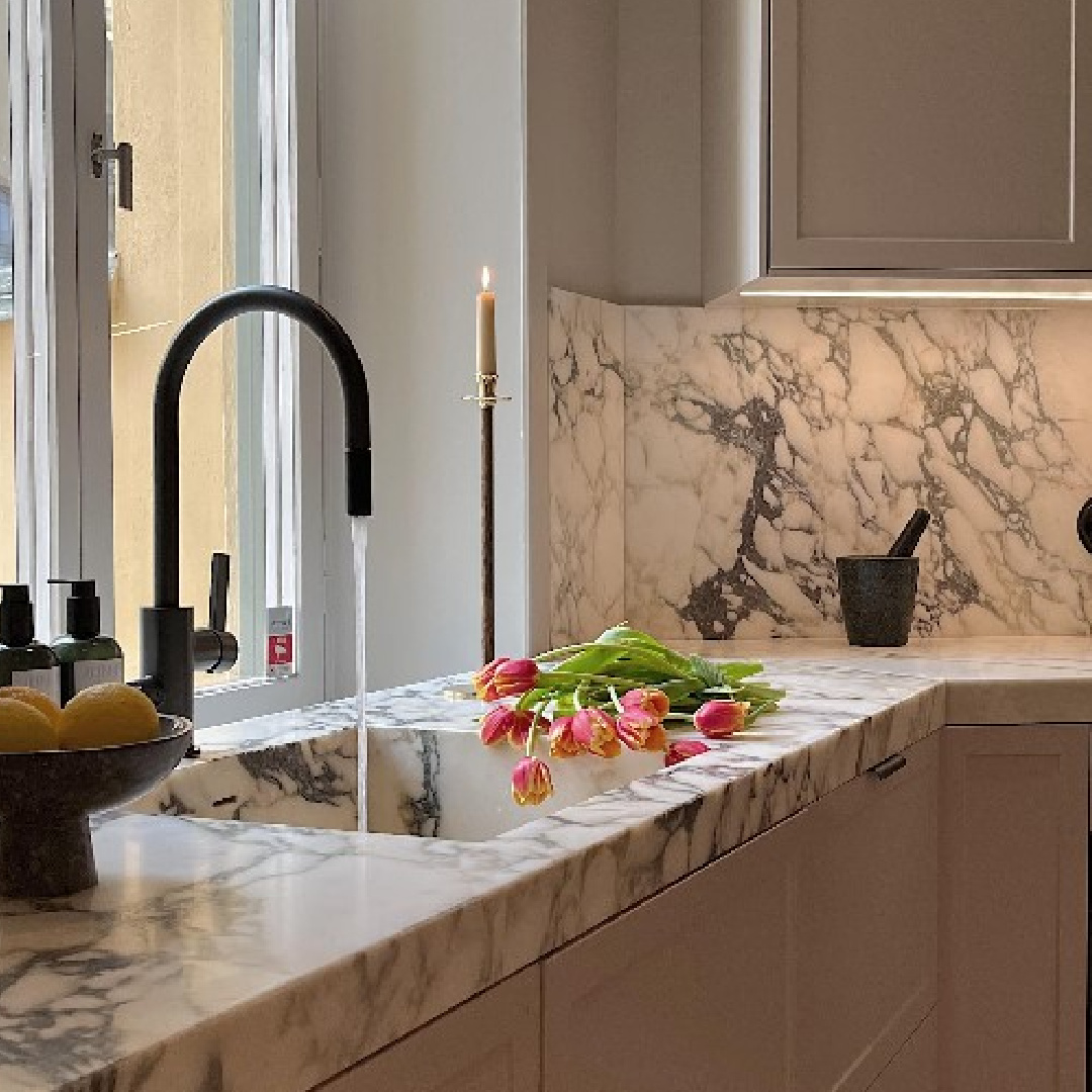 Romantic minimal modern Swedish kitchen with marble integrated sink, black faucet, and chic accessories - Louis Hjorth. #swedishkitchens #minimalkitchens