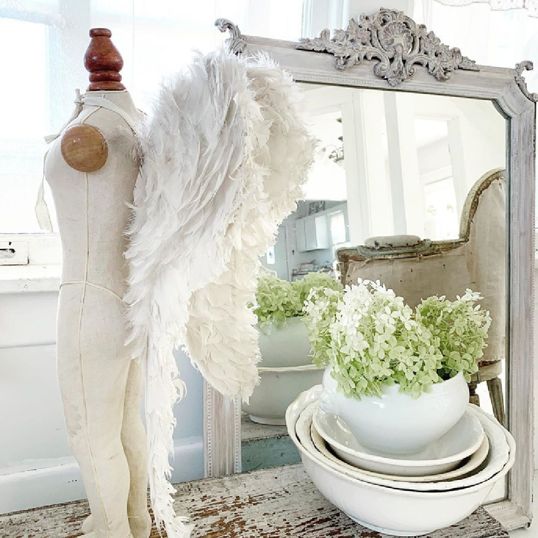 Antique angel wings on a mannequin near a French Nordic mirror, ironstone, and hydrangea - My Petite Maison. #nordicfrench #vintagefrench