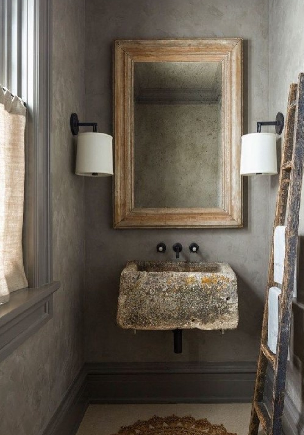 Noa Santos designed rustic modern minimal luxe bath with trough sink, plaster walls, ladder, and muddy earth tones. #luxebath #minimalluxe #troughsinks