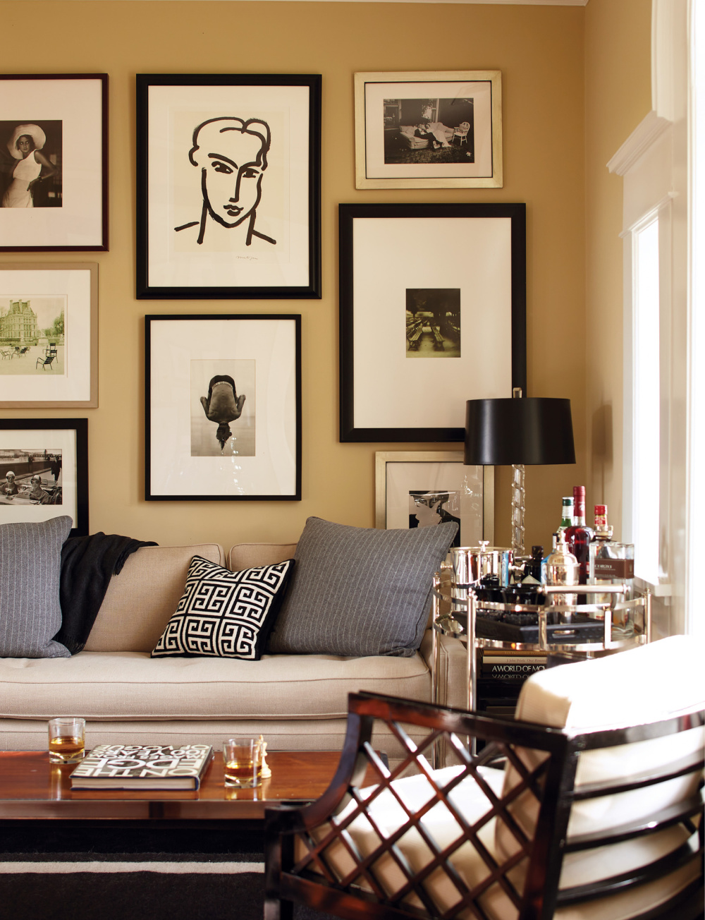 Mustard toned gallery wall in an elegant interior by David Jimenez in PARISIAN BY DESIGN (Rizzoli, 2022). #parisianinteriors