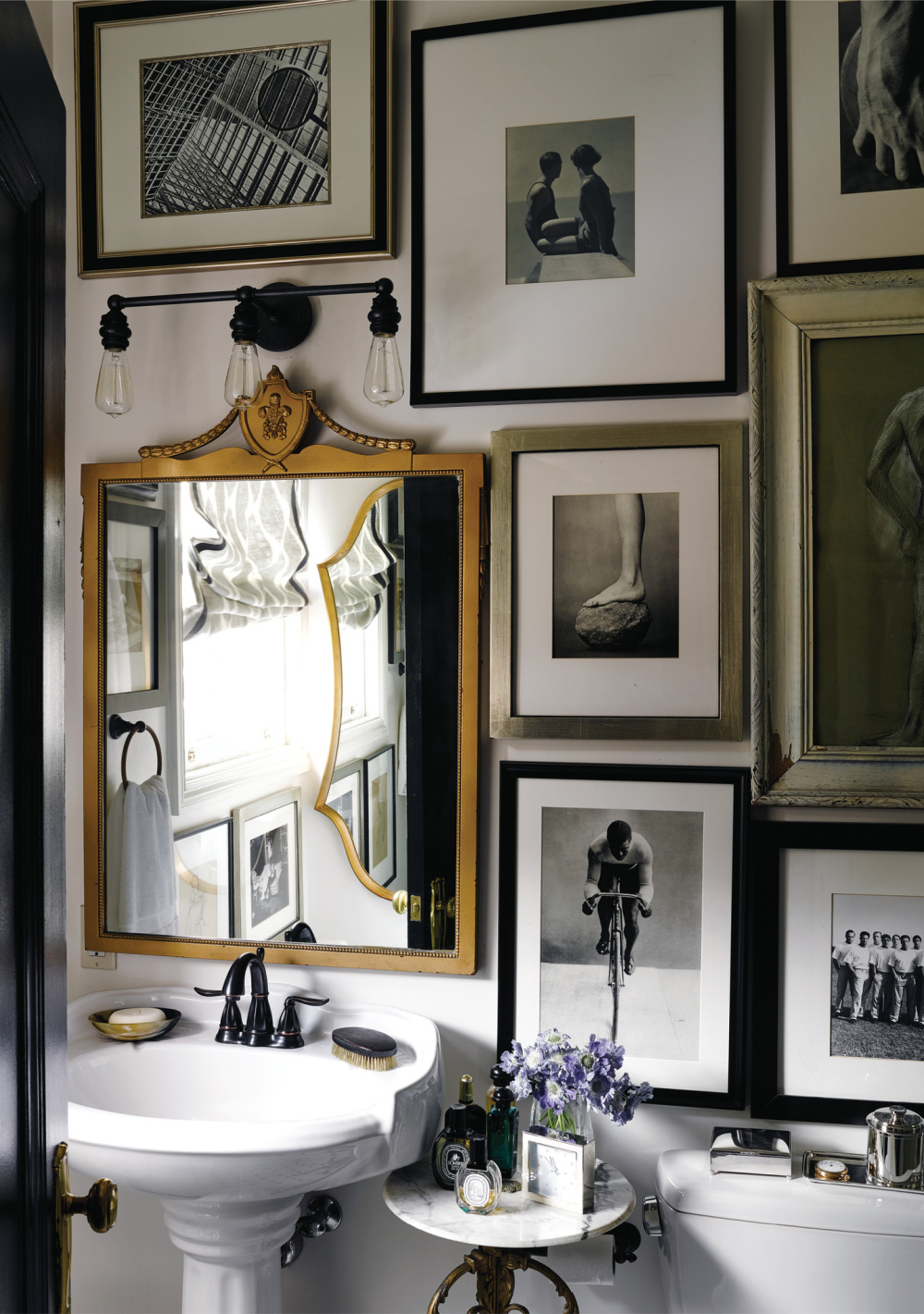 Gallery wall in a classic French bathroom with pedestal sink - design by David Jimenez in PARISIAN BY DESIGN (Rizzoli, 2022). #parisianinteriors