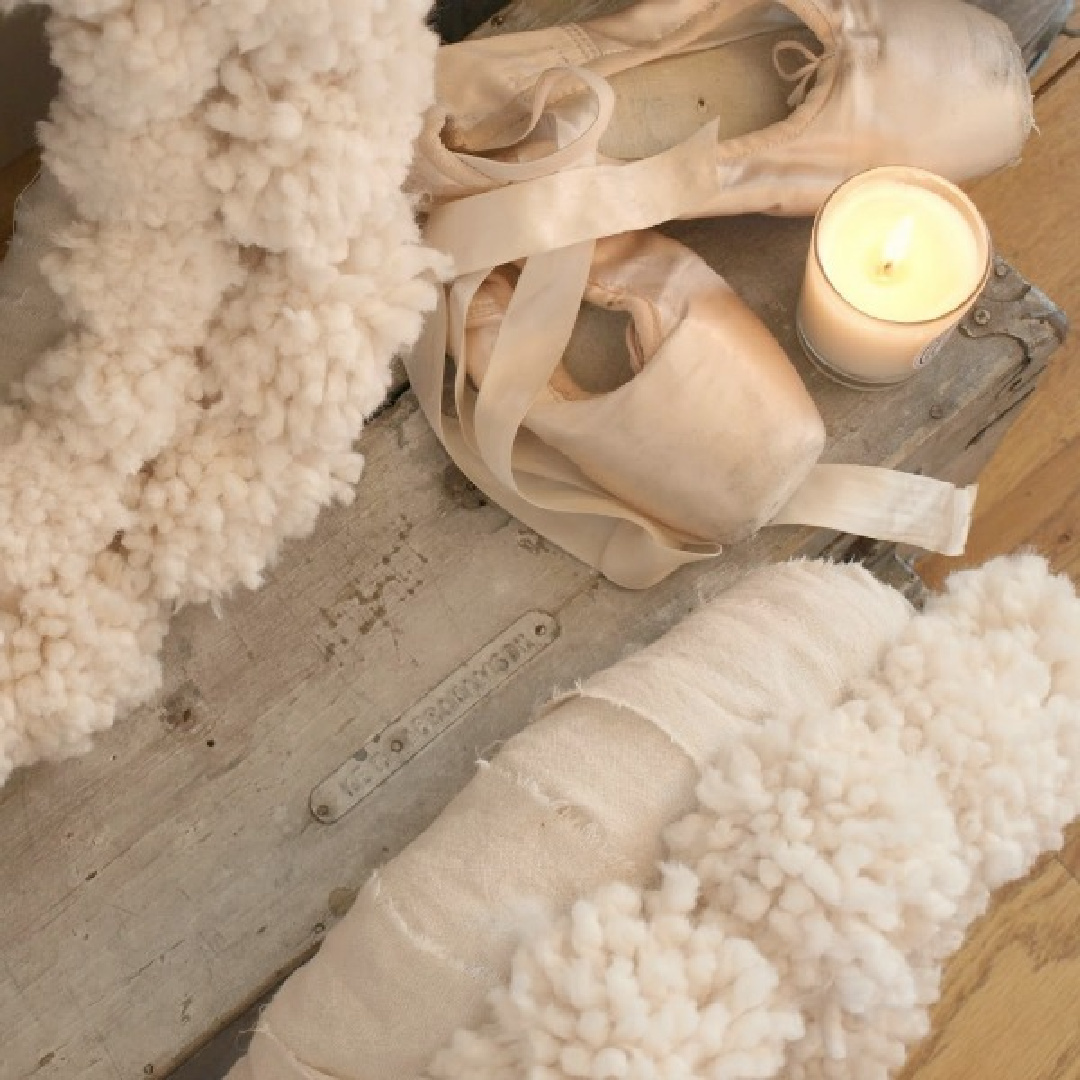 Pink pointe shoes and fluffy white pom pom wreaths for rustic pink Christmas vignette by Hello Lovely Studio. #pointeshoes #pinkchristmas #pompomwreaths