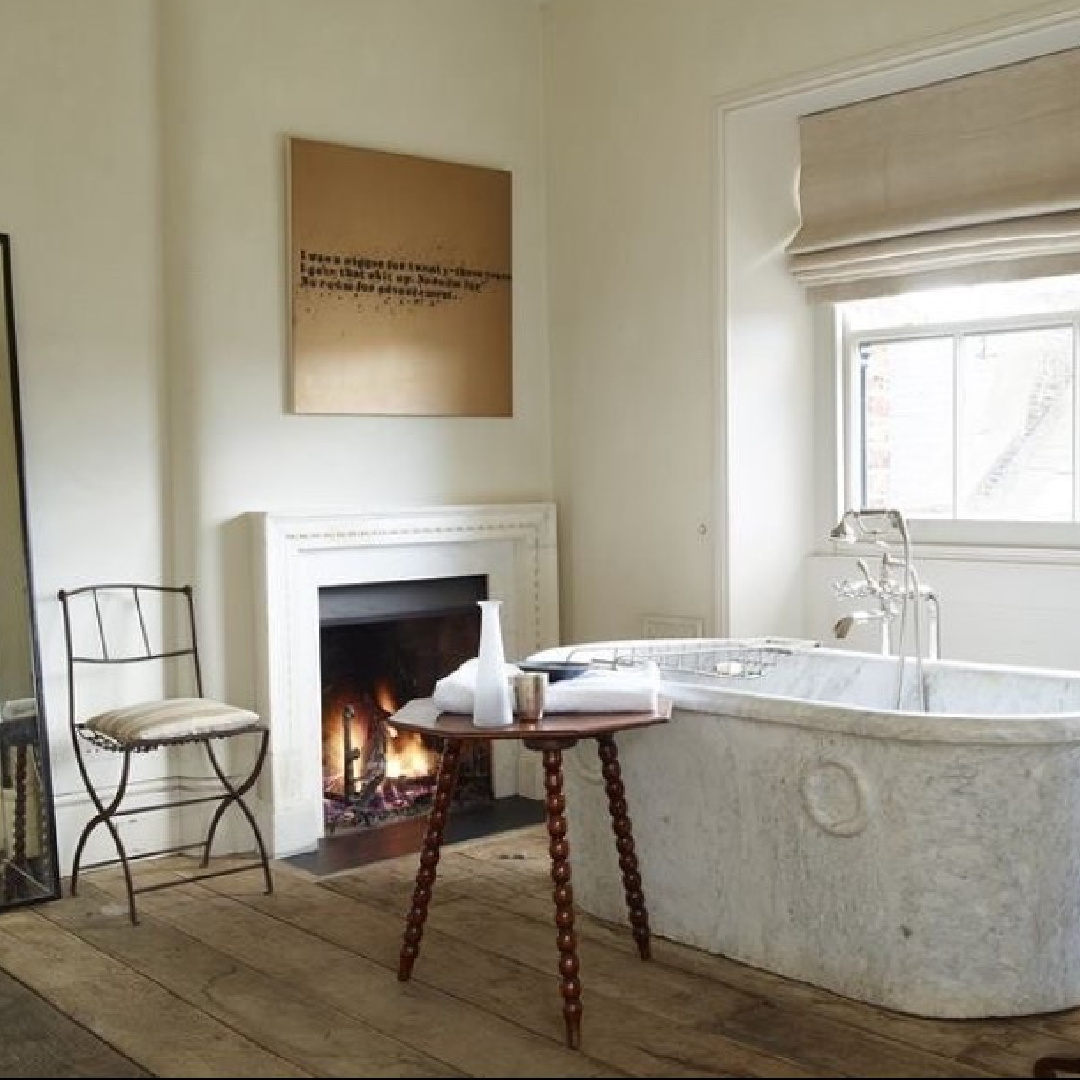 Luxurious and ethereal minimal bath with fireplace, hardwood flooring, soaker tub and neutrals - Rose Uniacke.