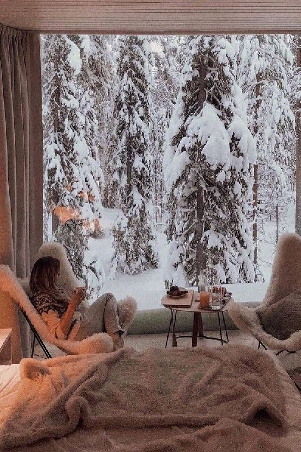 Winter wonderland woods in snow and cozy room with sherpa chairs - @theglampingland. #cozychristmas #snowywoods