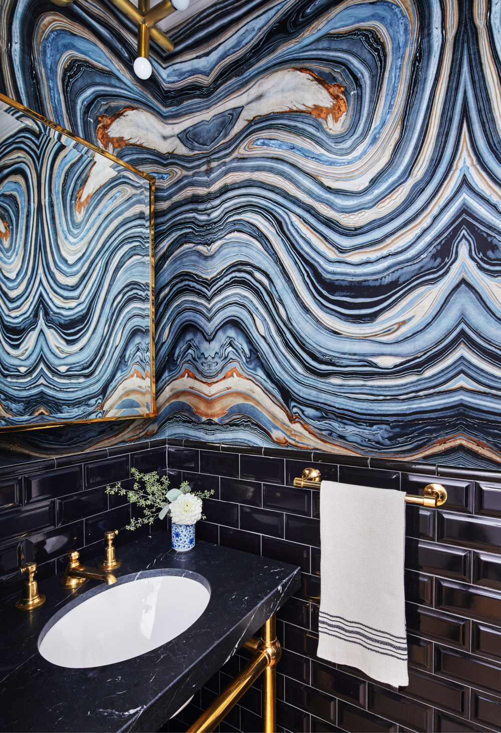 Blue agate wallcovering and luxurious fixtures in THE ULTIMATE BATH by Barbara Sallick (Rizzoli, 2022).