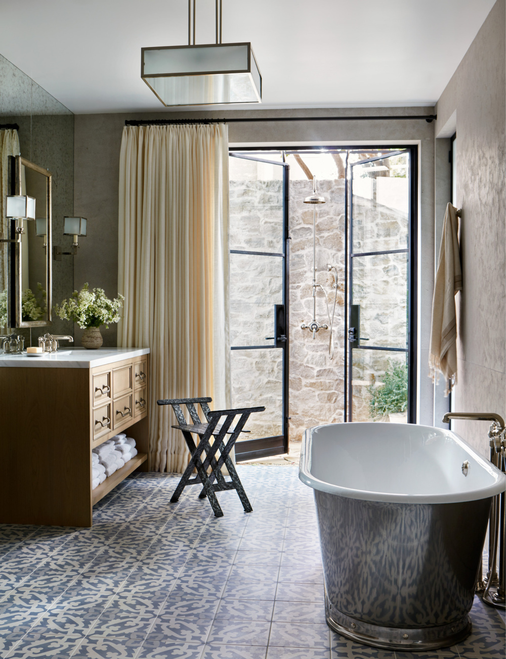 Luxurious fantasy bath with soaking tub and steel doors to outdoors - in THE ULTIMATE BATH by Barbara Sallick (Rizzoli, 2022).