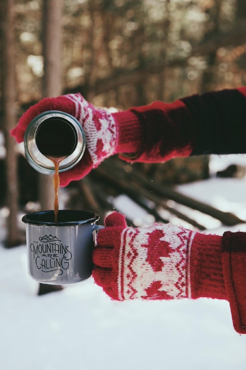 Red mittens, snowy woods, and hot chocolate poured from thermos - @unitedbyblue. #wintercozy #snowywoods