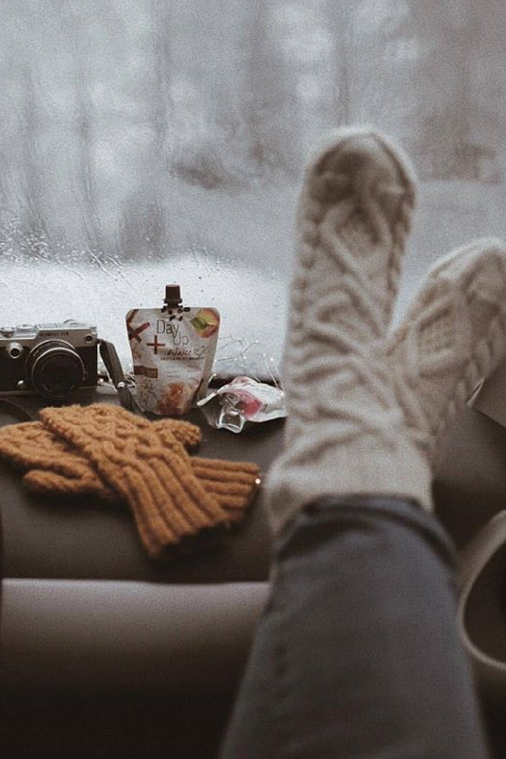 Beautiful handknit wool cableknit socks kicked up on dashboard with snowy woods outside - @woolsocool. #cozysocks