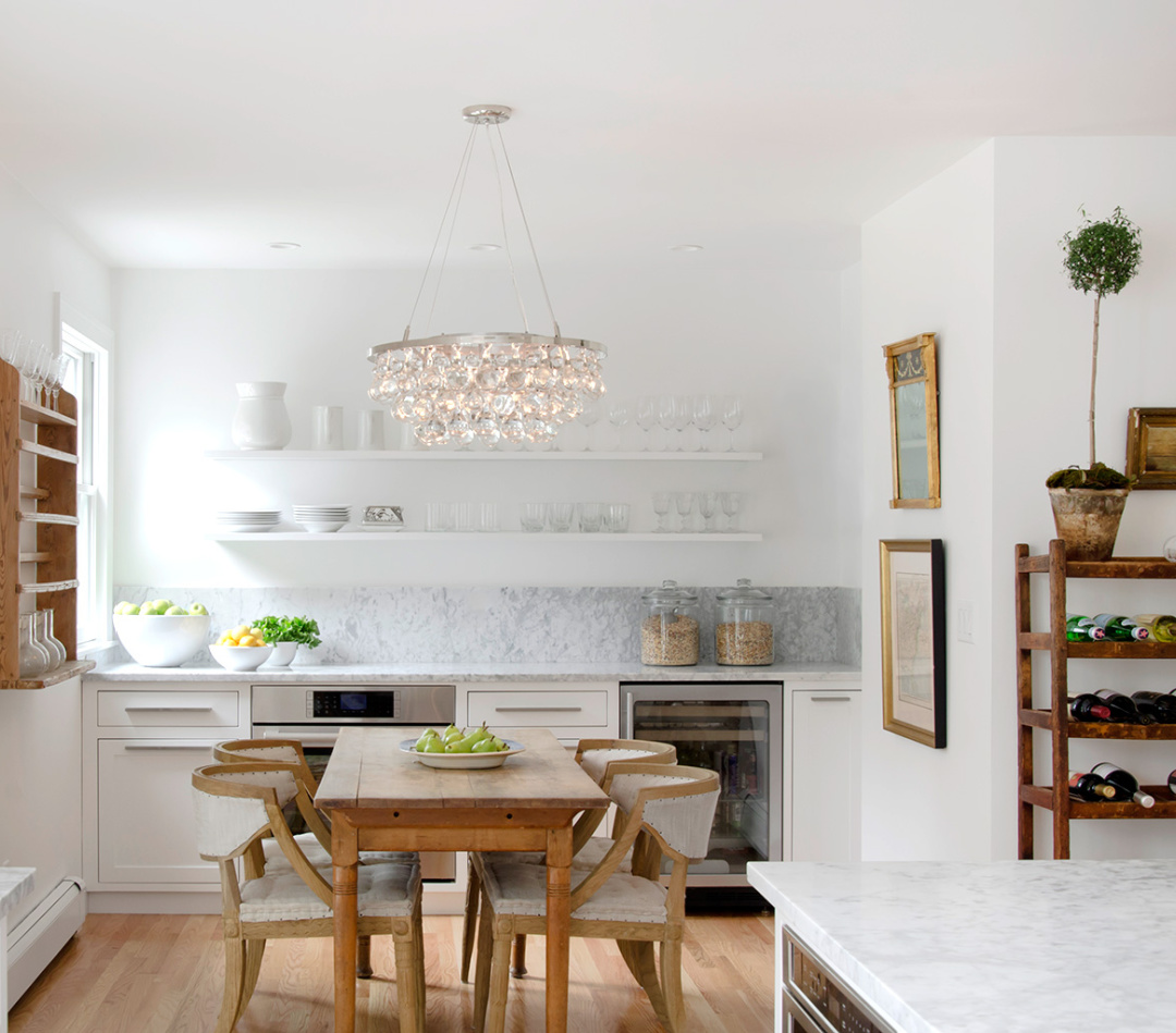 Chic modern country white kitchen with vintage accents, white marble, wood floors, and design by Kelly McGuill. Photo by Tamara Flanagan. #warmwhitekitchens