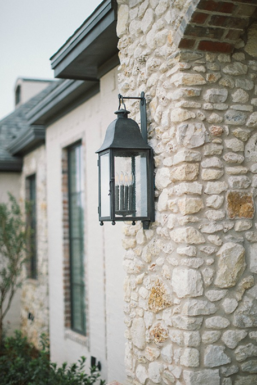 Detail of brick and stone on French country new house exterior. Brit Jones photography.