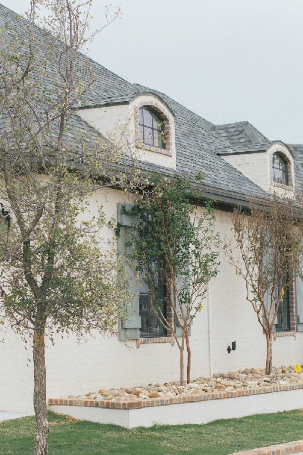 Detail of brick and stone on French country new house exterior. Brit Jones photography.