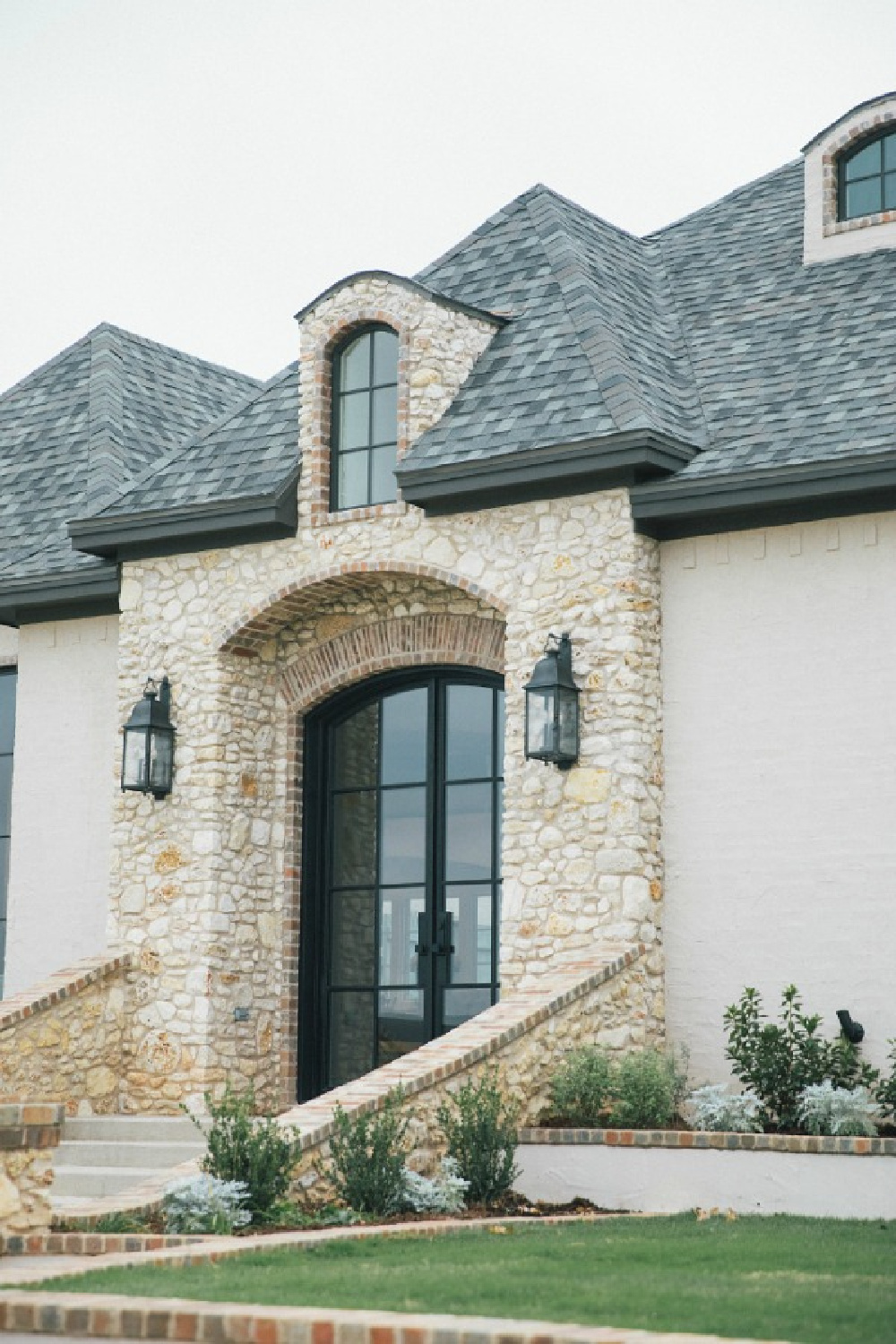 Detail of brick and stone on French country new house exterior. Brit Jones photography.