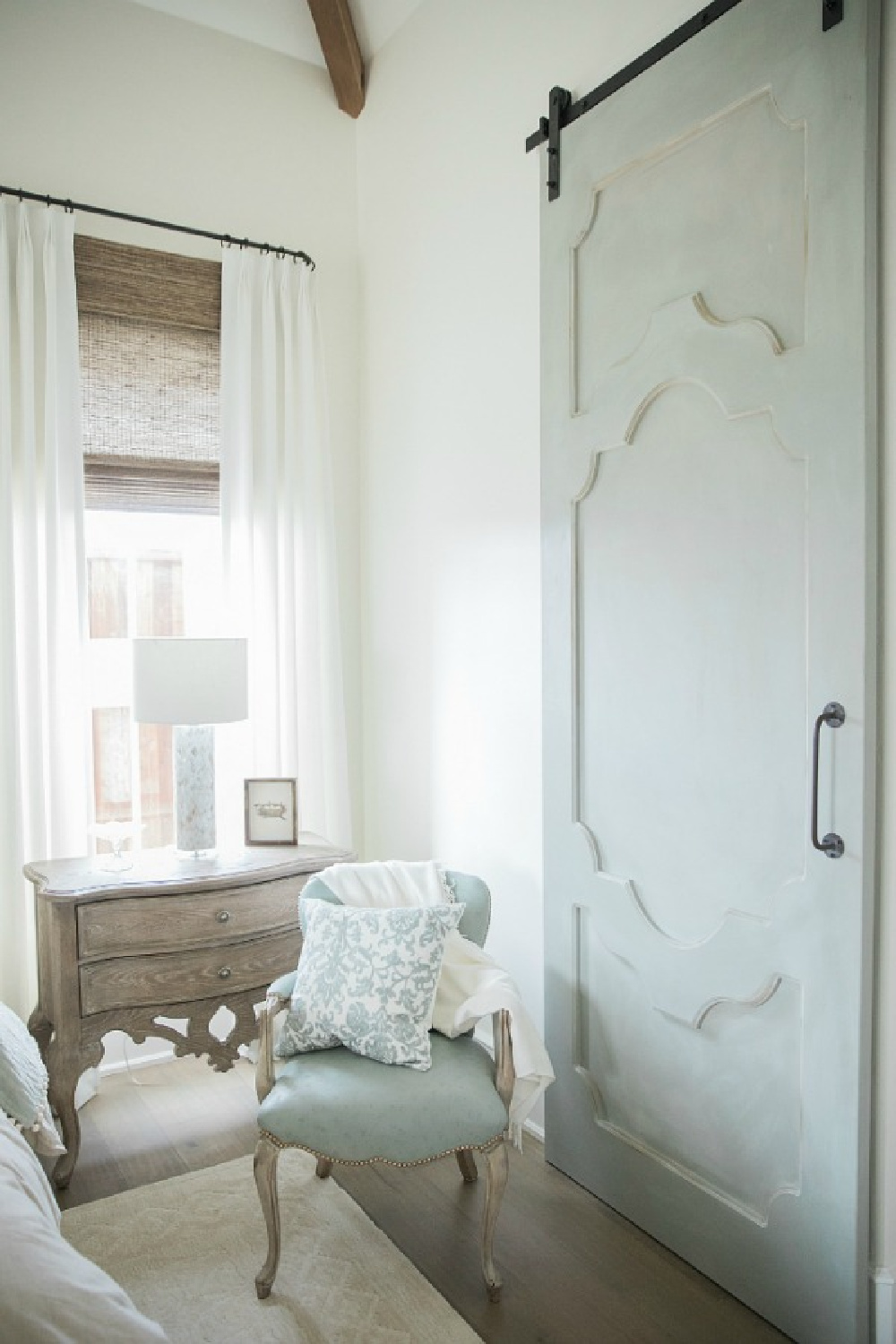 French country farmhouse white bedroom with Duck Egg blue barn door. Sherwin Williams Alabaster paint color on walls. Brit Jones Design.