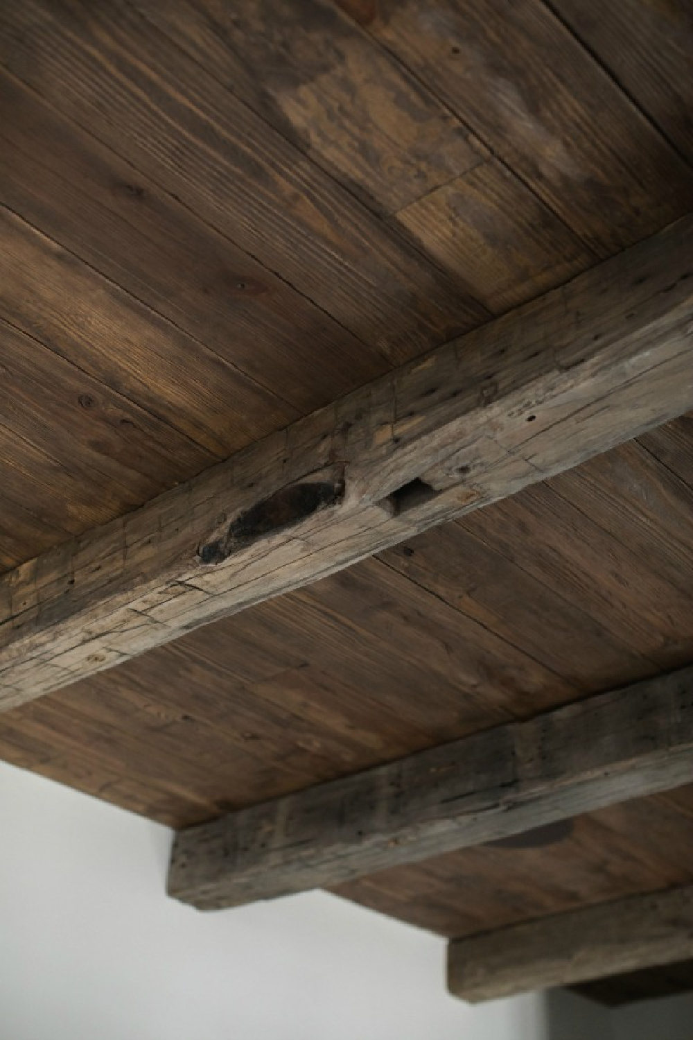 Rustic and dark reclaimed wood and cedar ceiling. Brit Jones Design.