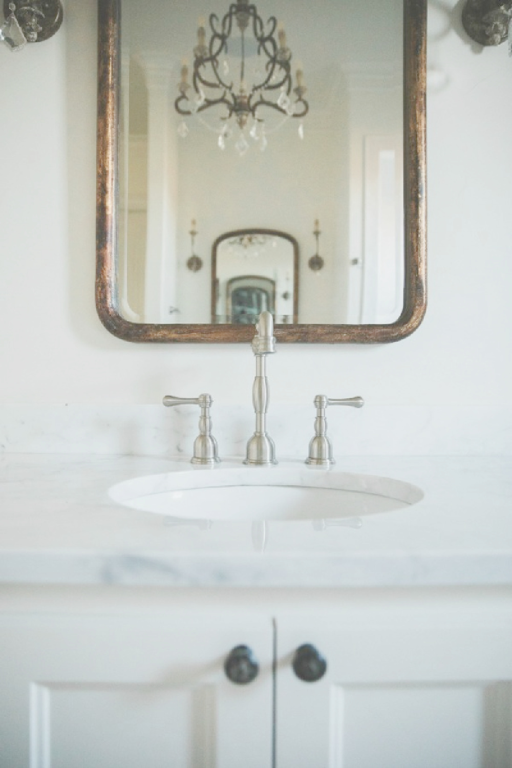 French country farmhouse white bathroom. Sherwin Williams Alabaster paint color on walls. Brit Jones Design.