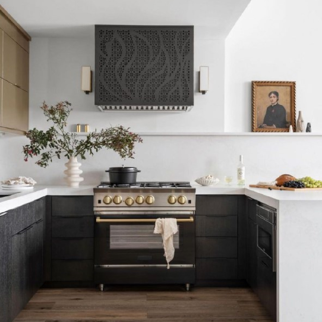 Custom black range hood in modern luxe Alison Victoria designed Atlanta loft on HTV's Windy City Rehab. Photo: Rustic White Interiors; Styling: Courtney Favini. House Beautiful.