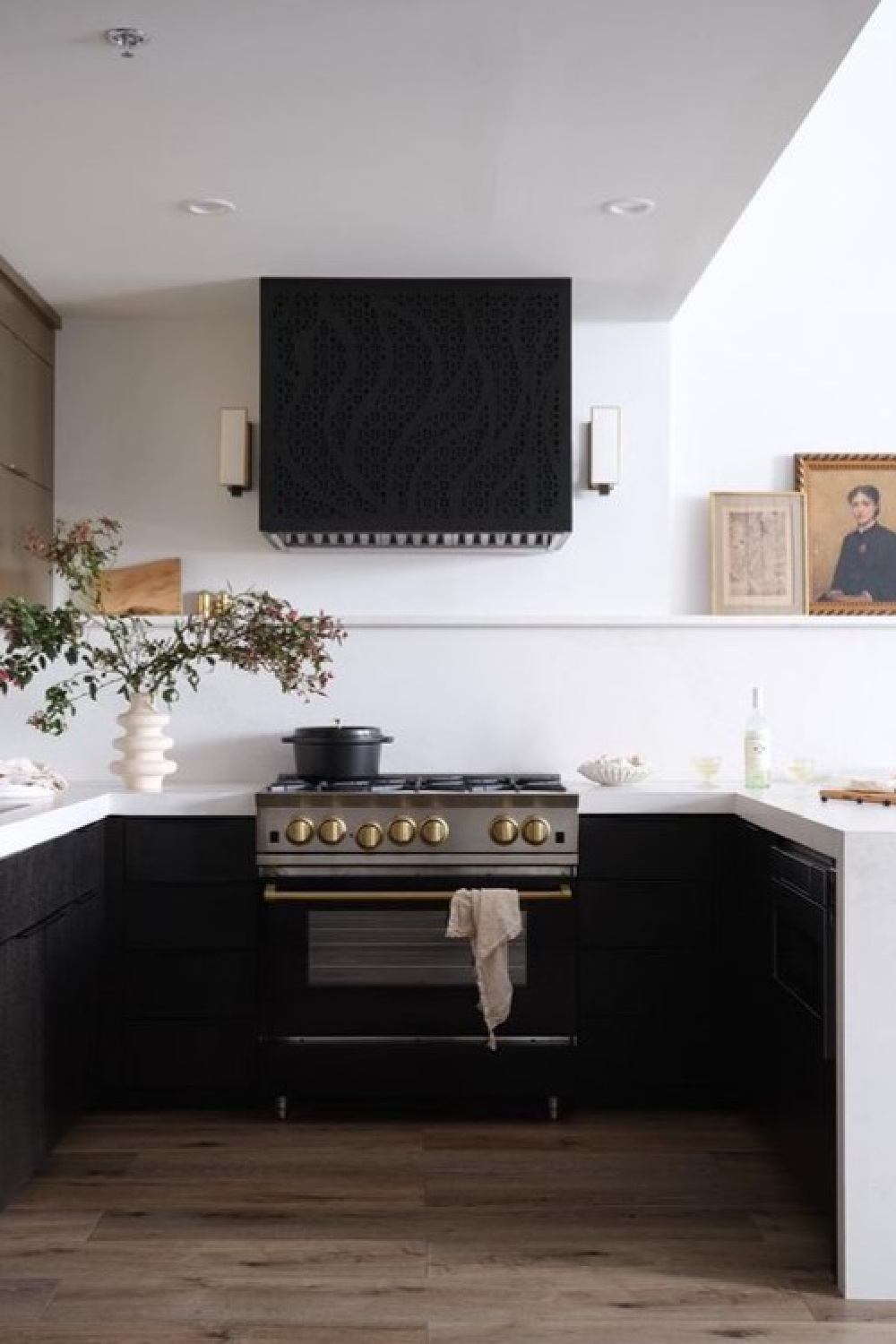 Kitchen with custom black range hood in beautiful Alison Victoria designed Atlanta loft on HTV's Windy City Rehab. Photo: Rustic White Interiors; Styling: Courtney Favini. House Beautiful.