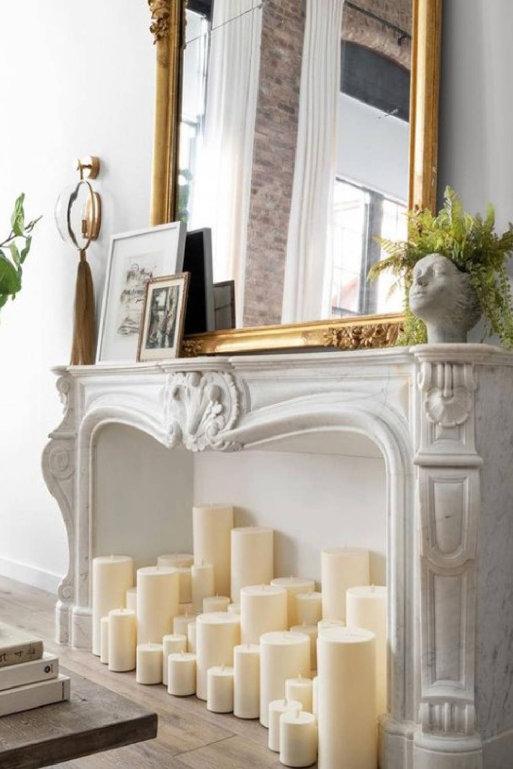 French fireplace surround with candles in beautiful Alison Victoria designed Atlanta loft on HTV's Windy City Rehab. Photo: Rustic White Interiors; Styling: Courtney Favini. House Beautiful.