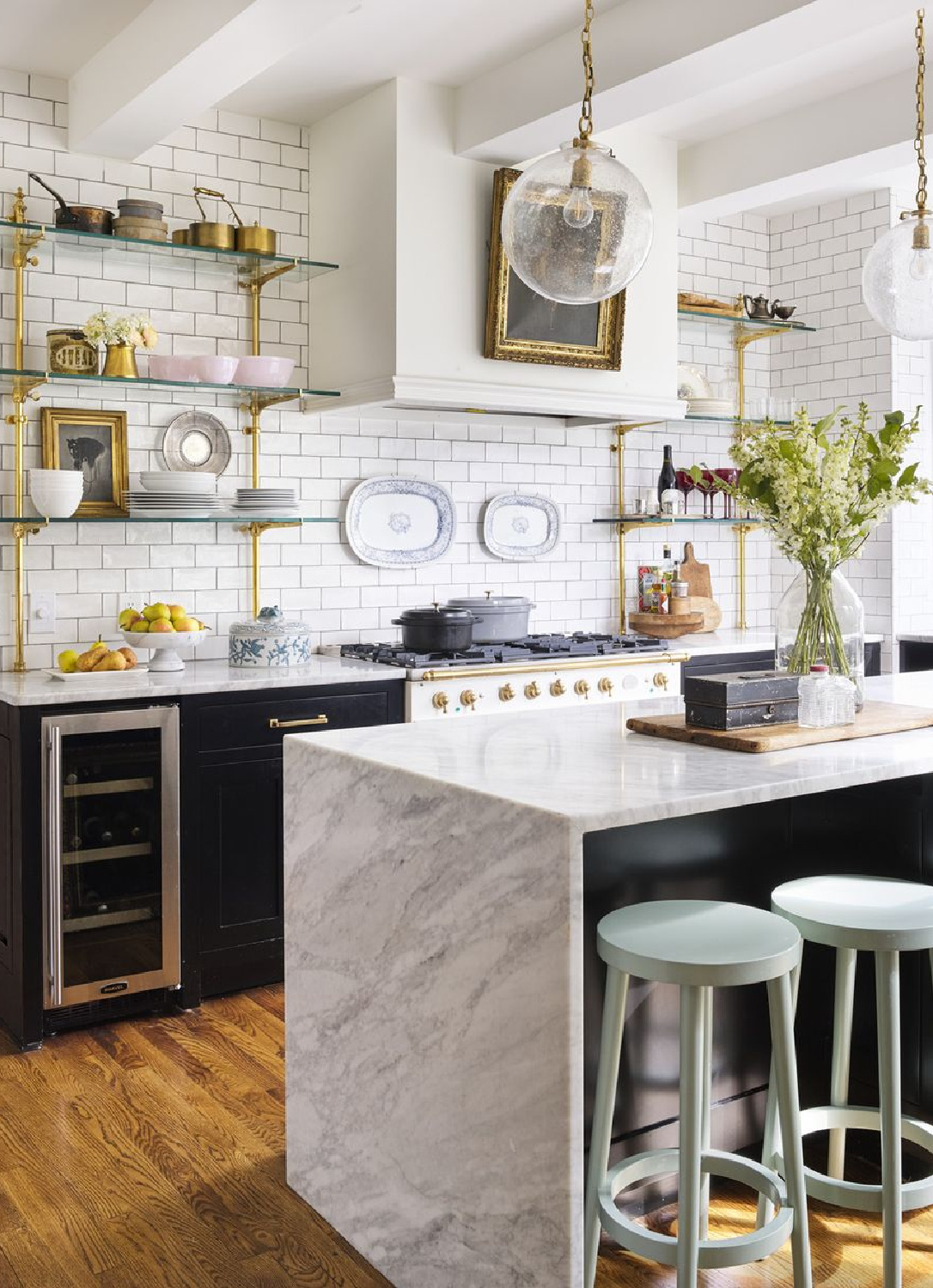 French bistro style white kitchen with open shelving and waterfall island - photo by Annie Schlechter.