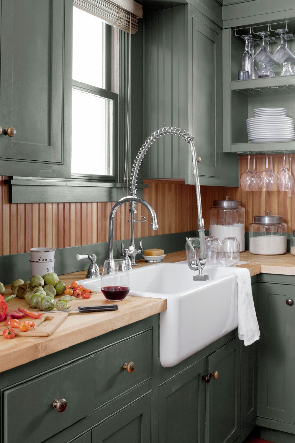 Beautiful green kitchen with fir beadboard backsplash (BM Mogegan Sage). Photo by Bjorn Wallander. #greenkitchens #rustickitchen #mohegansage