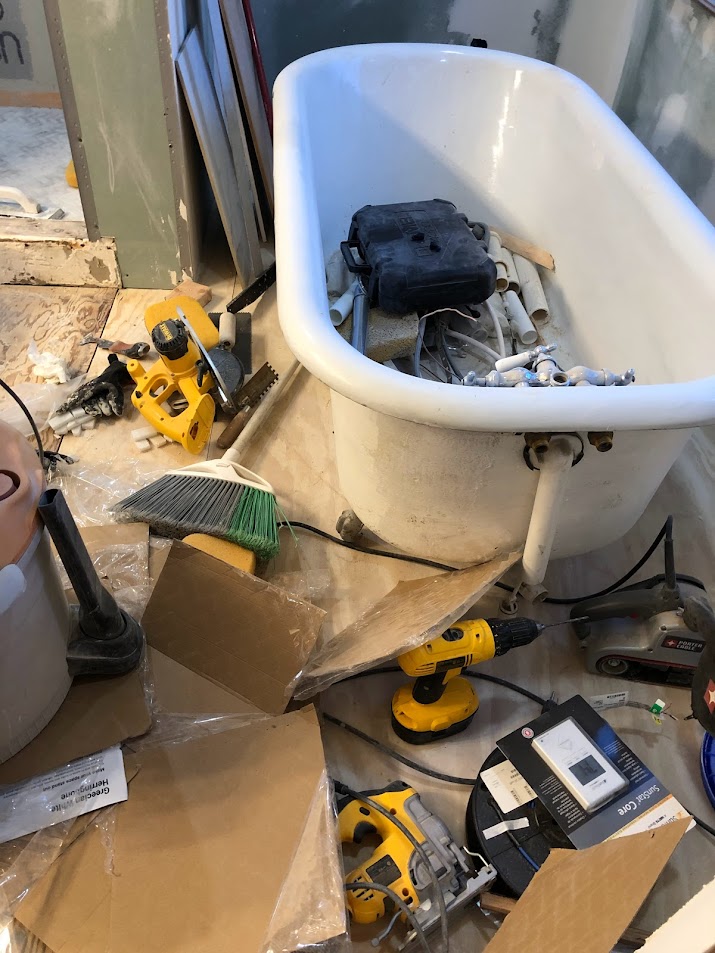 During renovation of our primary bath - clawfoot tub full of materials - Hello Lovely Studio.