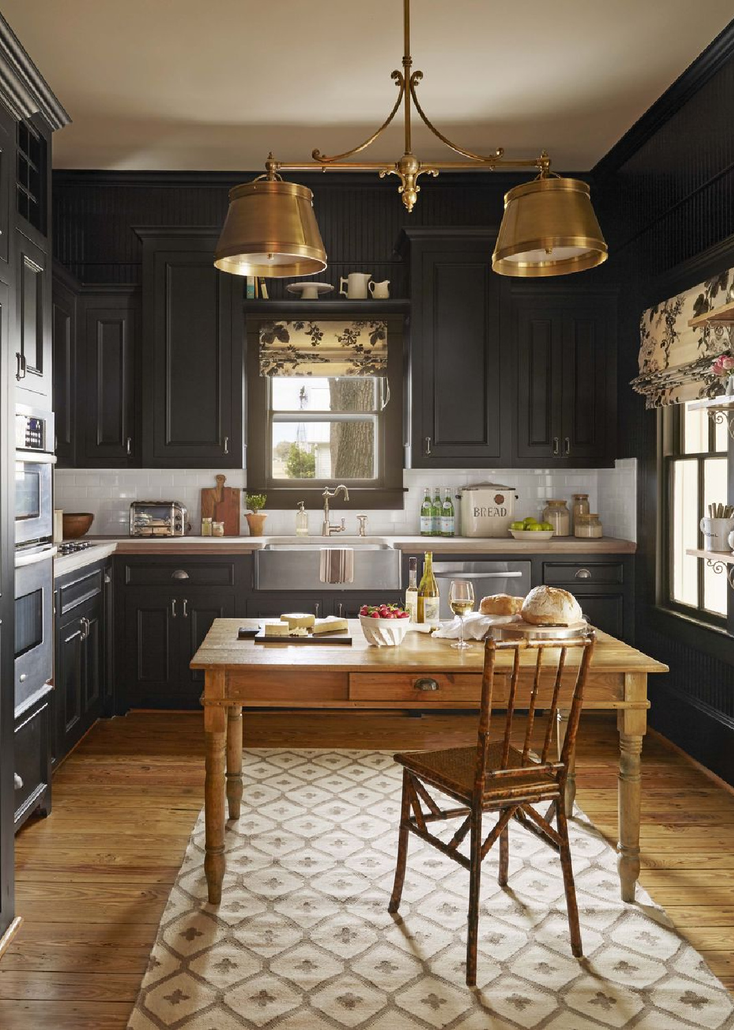 Farrow & Ball Pitch Black kitchen cabinets in a farmhouse by Bailey McCarthy - photo by Roger Davies. #farrowandballpitchblack #blackkitchens