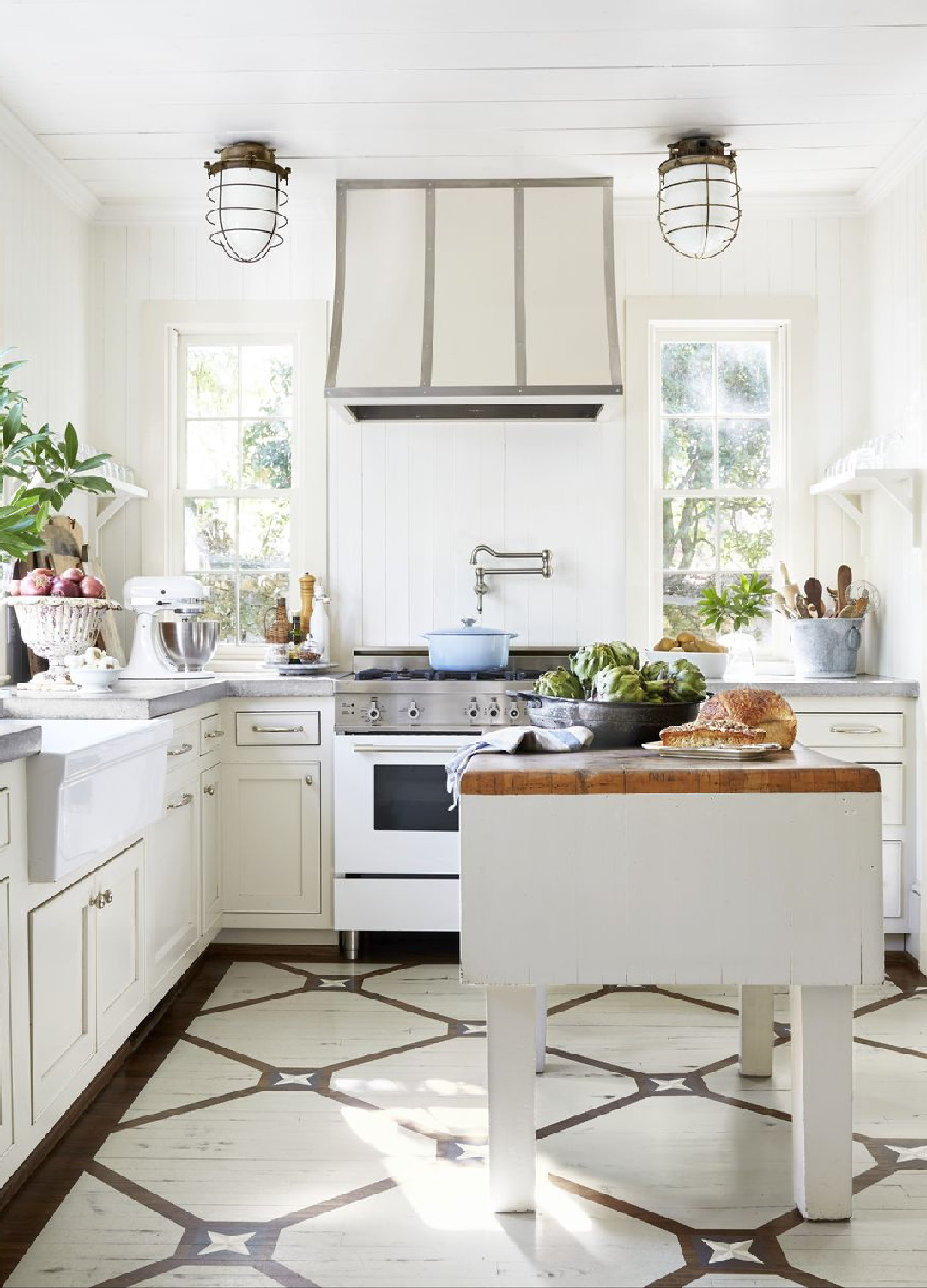 White cottage kitchen by Heather Chadduck (photo by David Hillegas) with stenciled painted wood floor. #paintedfloors #cottagekitchens