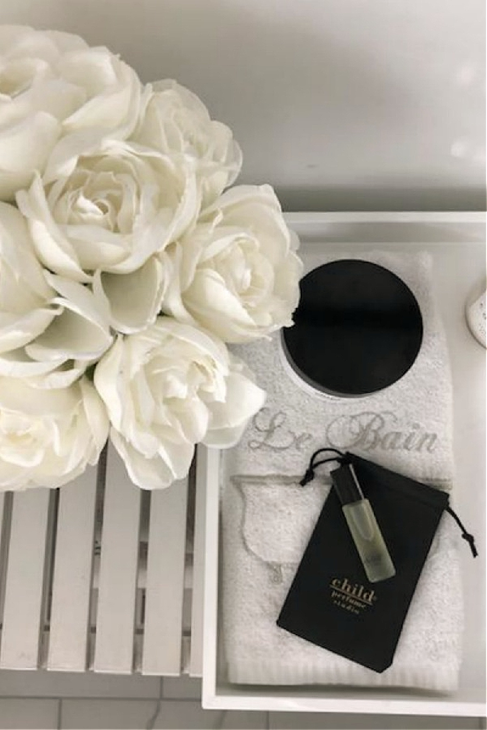 White roses and Child perfume roller ball in my white bath - Hello Lovely Studio.