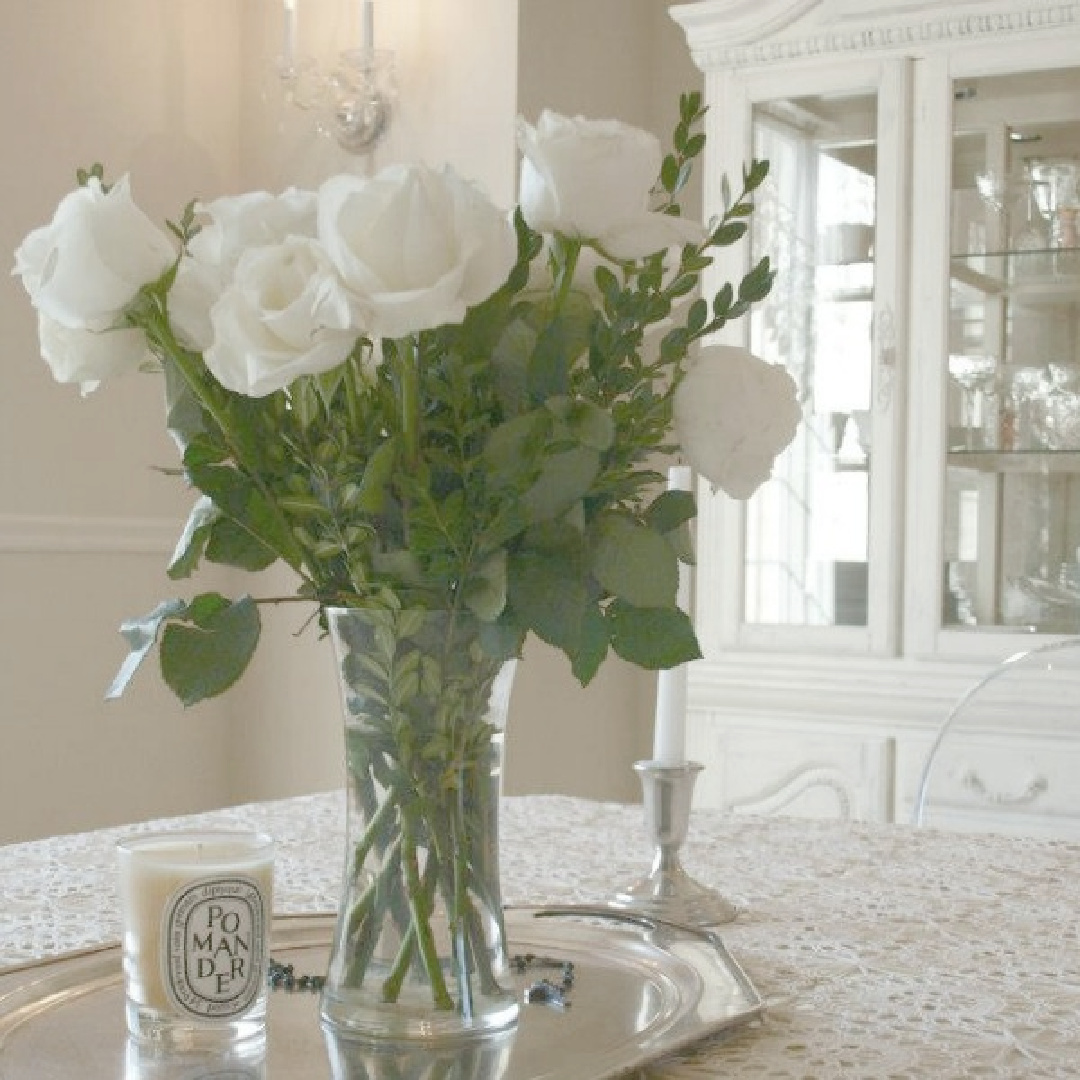 White garden roses on my dining room table with vintage lace tablecloth - Hello Lovely Studio.