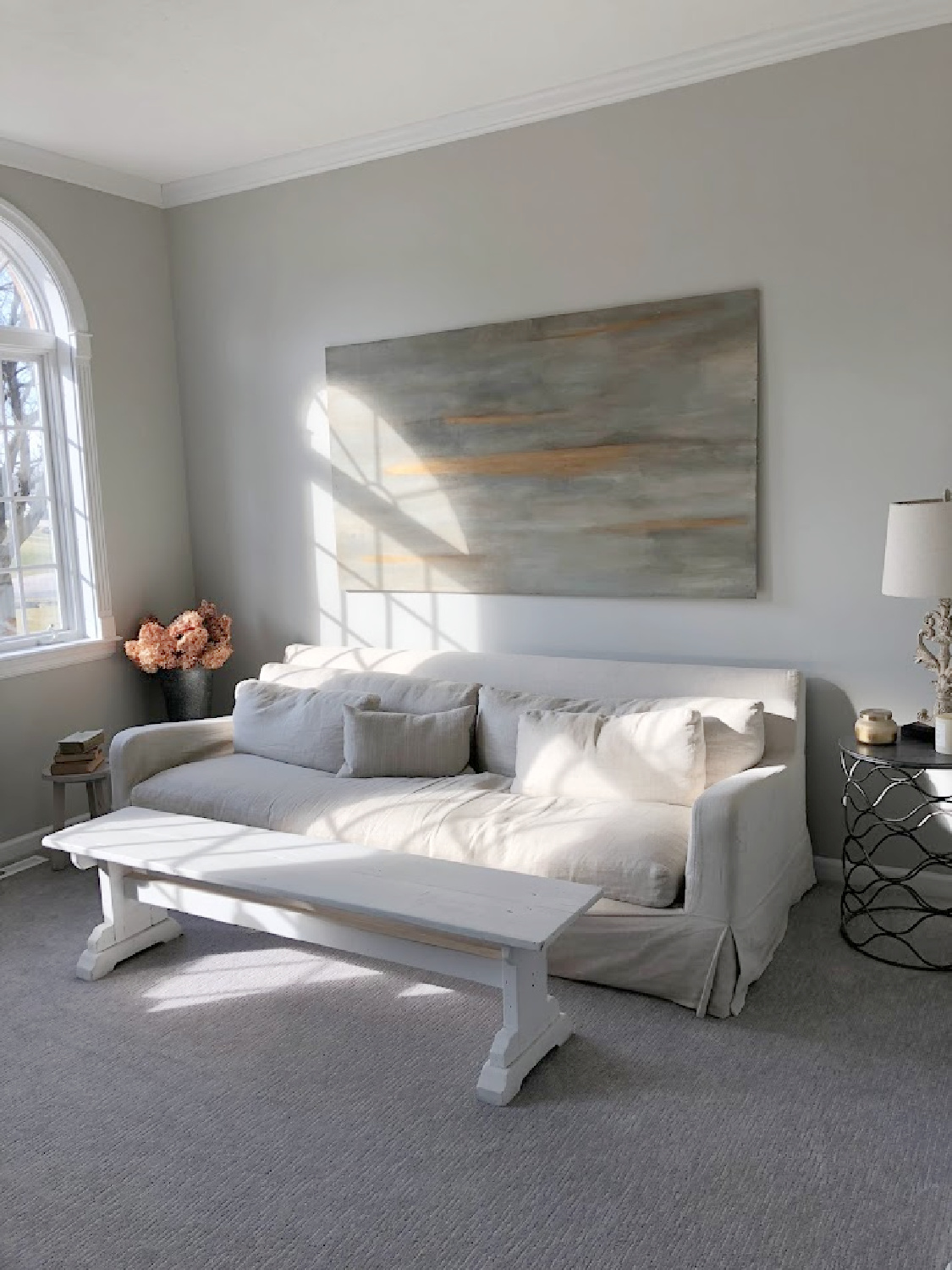 Belgian linen sofa in our living room at the Georgian. Walls painted SW Repose Gray. Abstract on wood by Michele, Hello Lovely Studio.