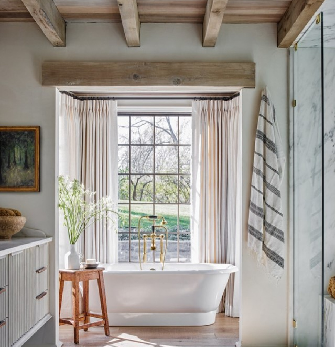 Magnificent architecture by Jeffrey Dungan Architects in a Kansas bathroom with soaking tub and rustic wood ceiling.