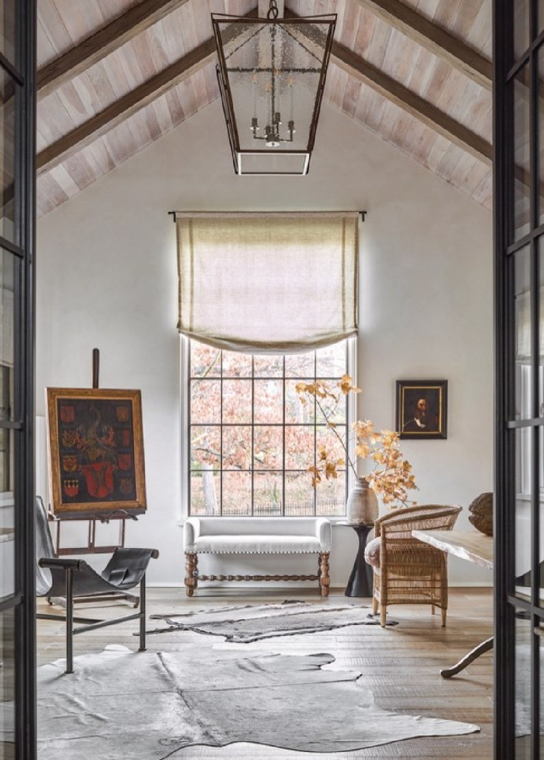 Grand and exquisite architecture in an office by Jeffrey Dungan with grand French doors and wood ceiling.