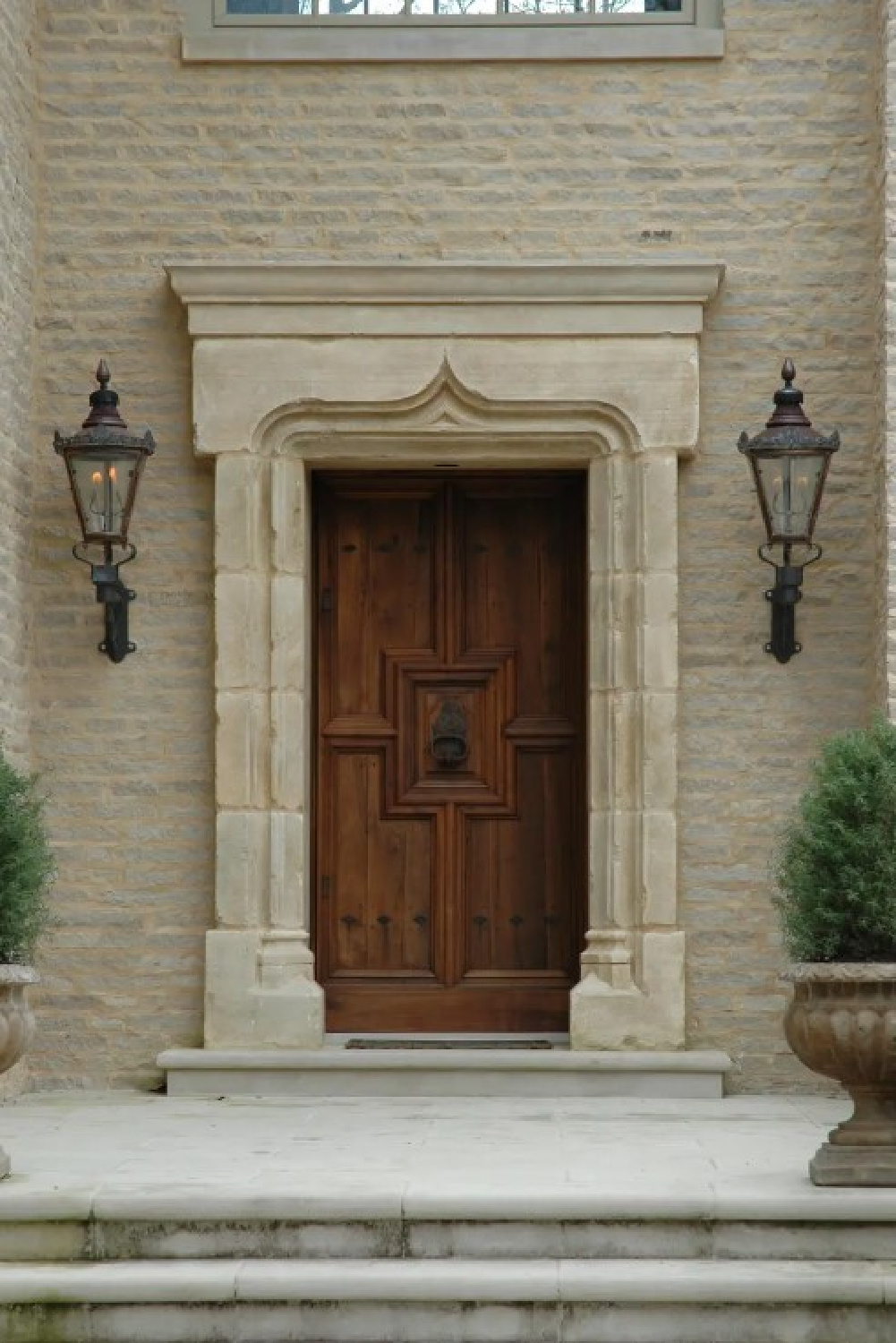 Breathtaking facade with stone, wood door, and lanterns - Jeffrey Dungan Architects. #oldworldstyle
