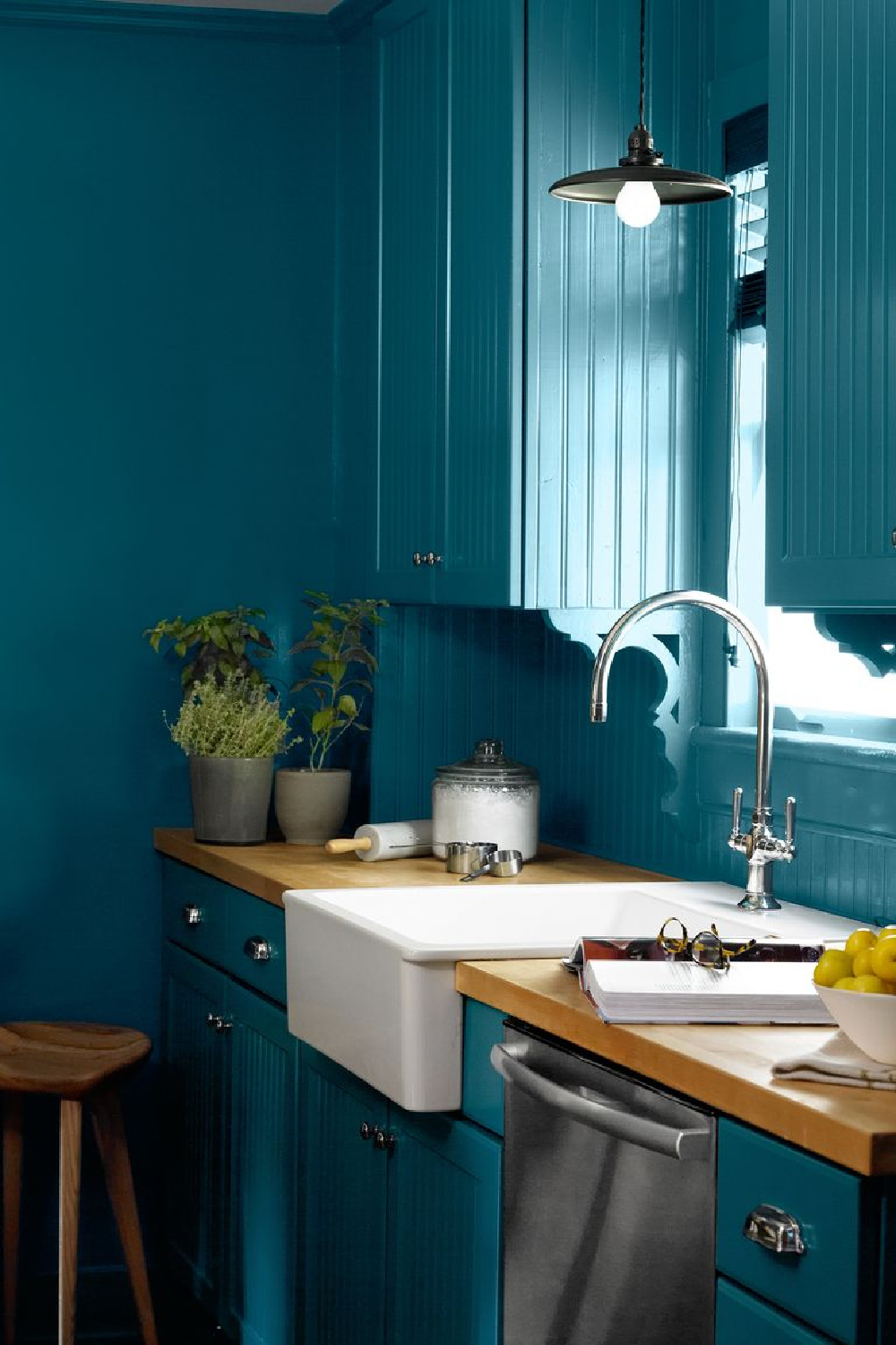 Varsity Blues (Benjamin Moore) painted cabinets, walls, and trim in a bold blue kitchen (photo by Miki Duisterhof). #bluekitchens #benjaminmoorevarsityblues